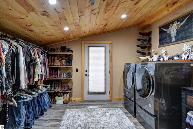 clothes washing area featuring washer and clothes dryer and wooden ceiling