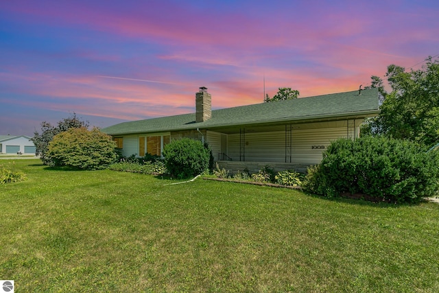 ranch-style home featuring a yard