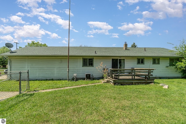 back of house with a wooden deck and a yard