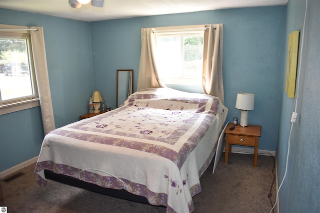 carpeted bedroom featuring visible vents, ceiling fan, and baseboards