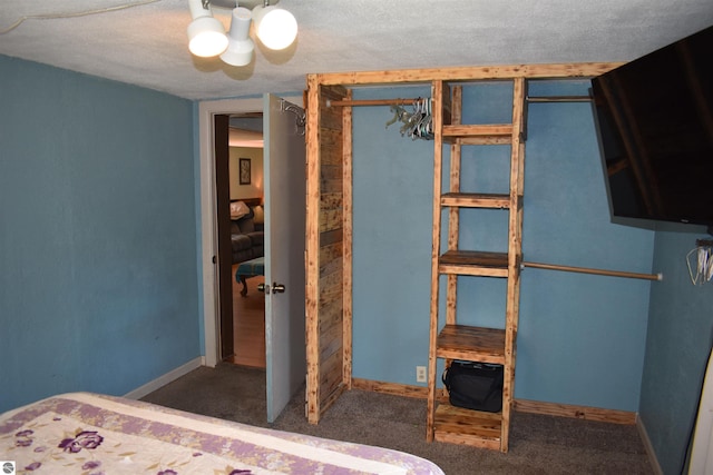 unfurnished bedroom featuring carpet flooring, a textured ceiling, and baseboards