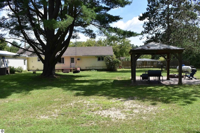 view of yard with a patio area, fence, and a gazebo