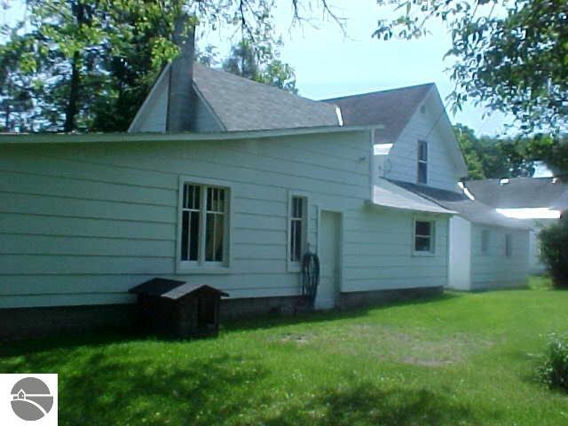 rear view of property featuring a yard