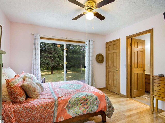 bedroom featuring ceiling fan, light wood-type flooring, and access to exterior