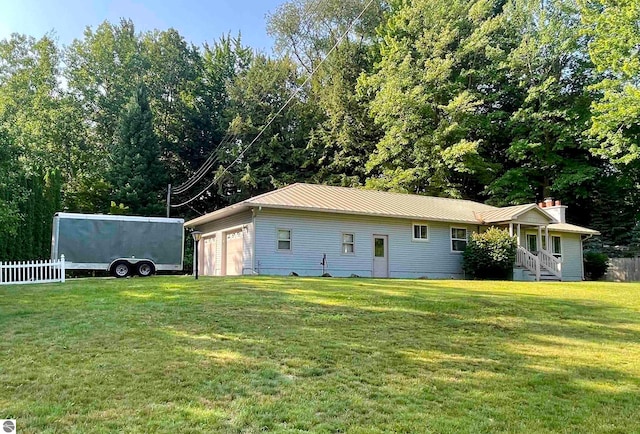 view of side of home with an outdoor structure, a yard, and a garage