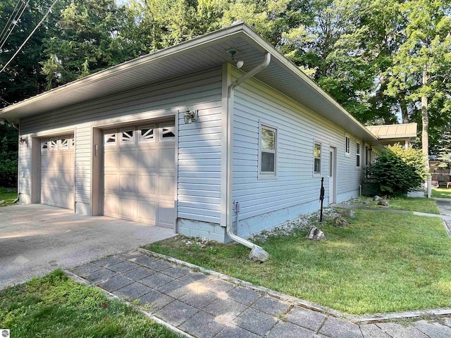 view of side of property with a garage and a yard