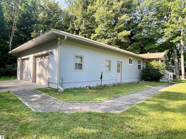 view of property exterior with a yard and a garage