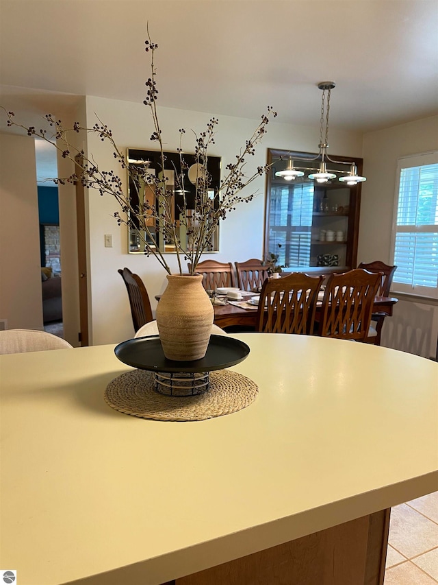 dining area featuring a chandelier and light tile patterned floors