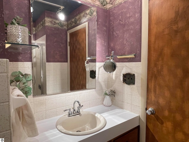 bathroom featuring tasteful backsplash, vanity, and tile walls