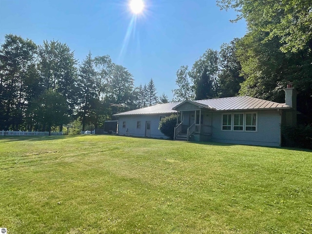 rear view of property with a lawn