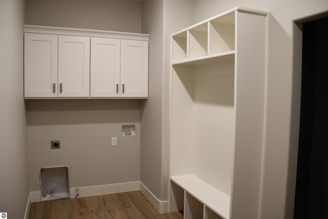 laundry room featuring light wood finished floors, baseboards, washer hookup, cabinet space, and electric dryer hookup