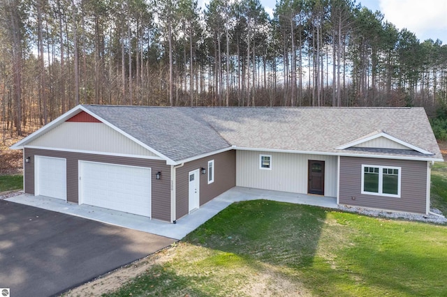 ranch-style house with a garage and a front lawn