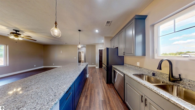 kitchen with ceiling fan, dark wood-type flooring, dishwasher, and light stone countertops