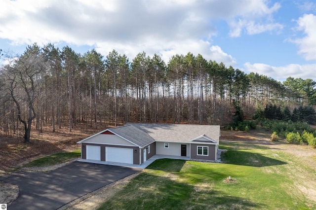 view of front of property featuring a garage and a front yard