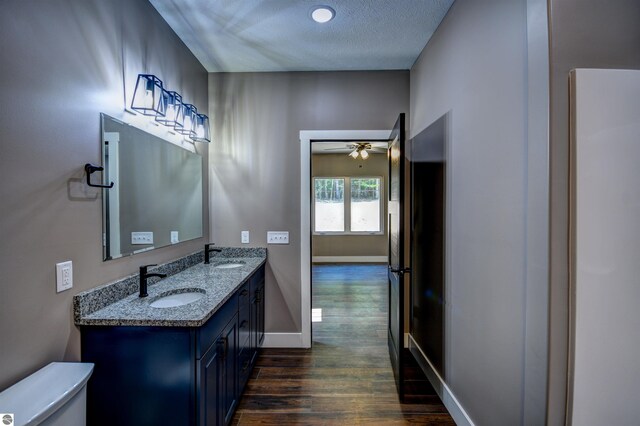 full bathroom featuring shower / bathing tub combination, wood-type flooring, vanity, and toilet