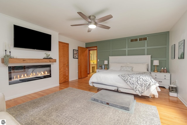 bedroom with ceiling fan and light hardwood / wood-style floors