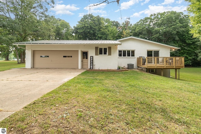 ranch-style home with a garage, central AC unit, a front lawn, and a deck