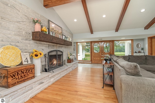 living room with light wood-type flooring and lofted ceiling