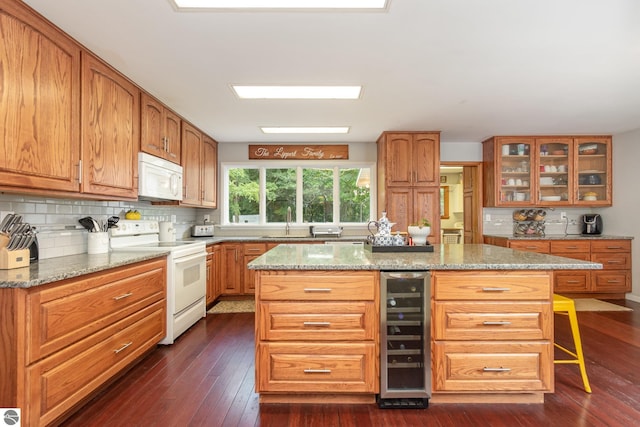 kitchen featuring wine cooler, dark hardwood / wood-style flooring, white appliances, and a kitchen island