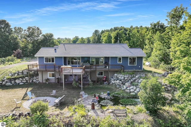 rear view of property with a wooden deck