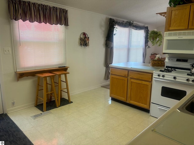 kitchen with white appliances and light tile patterned floors