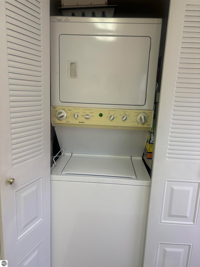 laundry room with stacked washer and dryer