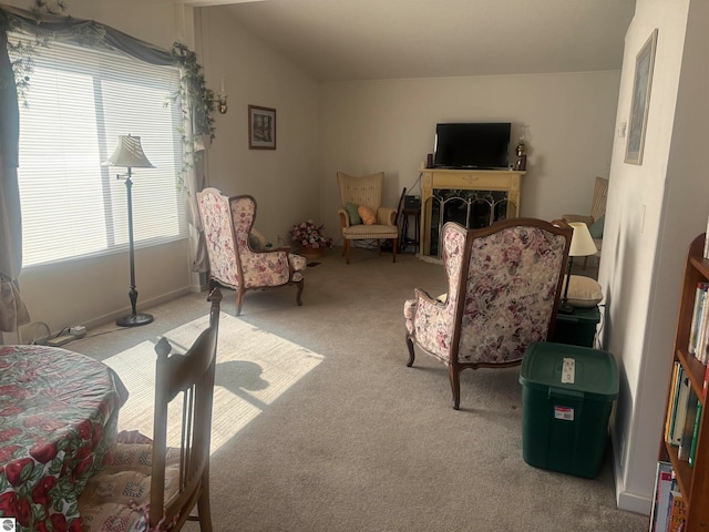 carpeted living room featuring lofted ceiling