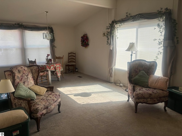 living area featuring vaulted ceiling and light carpet