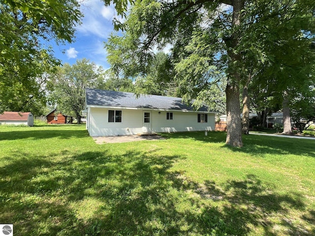 back of property featuring a lawn