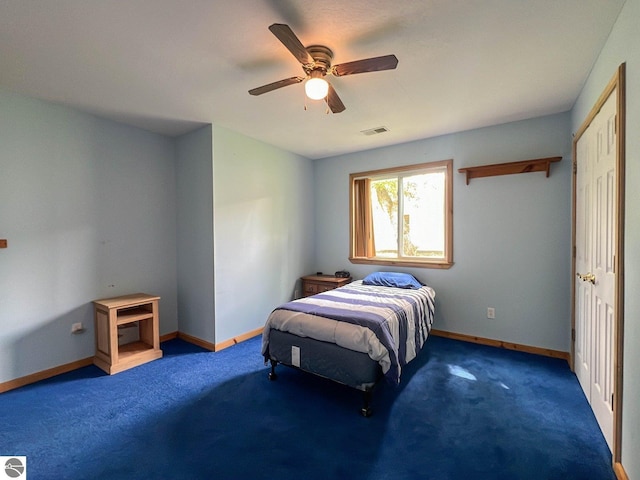 bedroom with dark carpet and ceiling fan