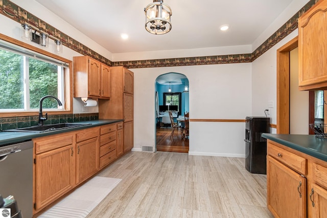 kitchen featuring sink, a notable chandelier, dishwasher, and light wood-type flooring