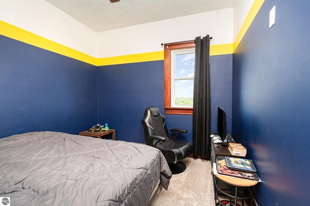 bedroom with carpet floors and a textured ceiling