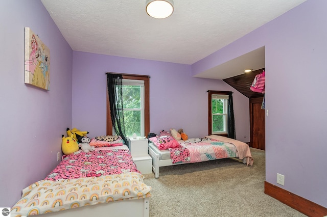 carpeted bedroom with a textured ceiling