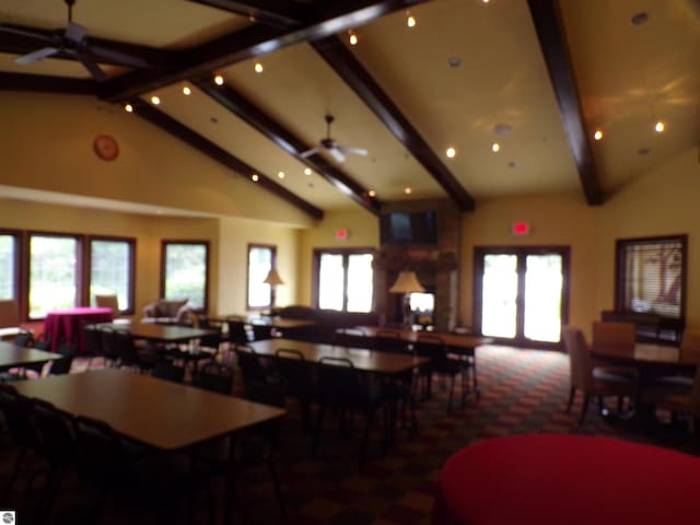 dining area with ceiling fan, high vaulted ceiling, beamed ceiling, and french doors