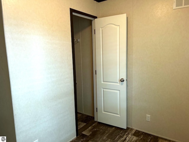 interior space featuring visible vents and dark wood finished floors