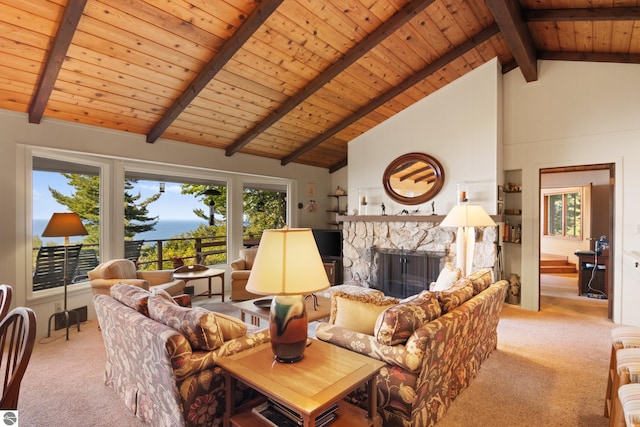 carpeted living room with beamed ceiling, a stone fireplace, high vaulted ceiling, and wooden ceiling