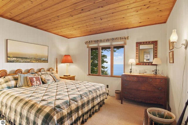 carpeted bedroom with a water view and wooden ceiling