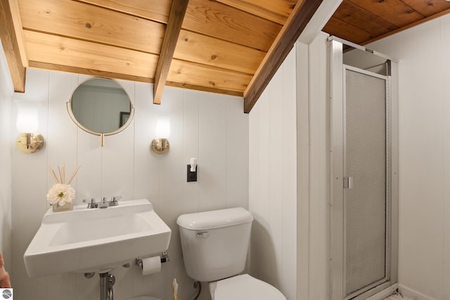 bathroom with beam ceiling, toilet, walk in shower, wood ceiling, and sink