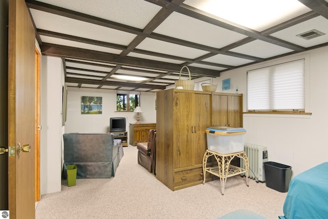 carpeted bedroom with coffered ceiling and radiator heating unit