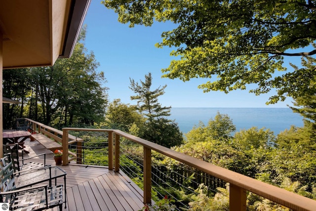 wooden terrace featuring a water view