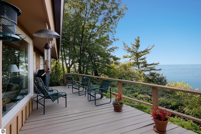 wooden terrace featuring a water view