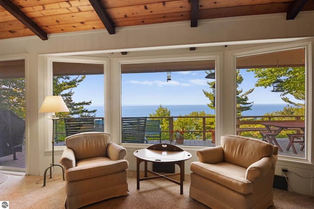 sunroom / solarium with a water view, beamed ceiling, and wood ceiling