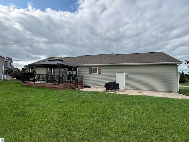 back of property with a lawn, a gazebo, a patio, and a wooden deck