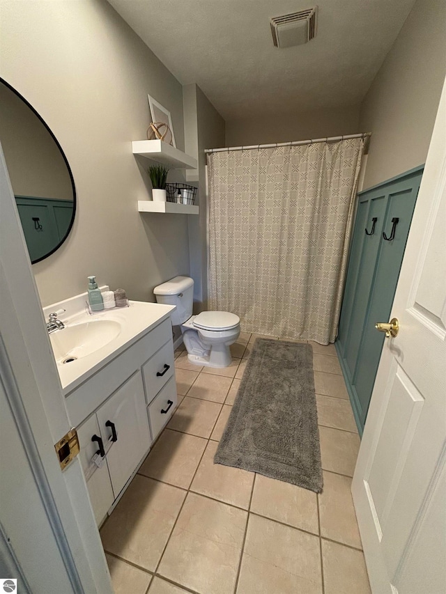 bathroom with tile patterned floors, vanity, and toilet