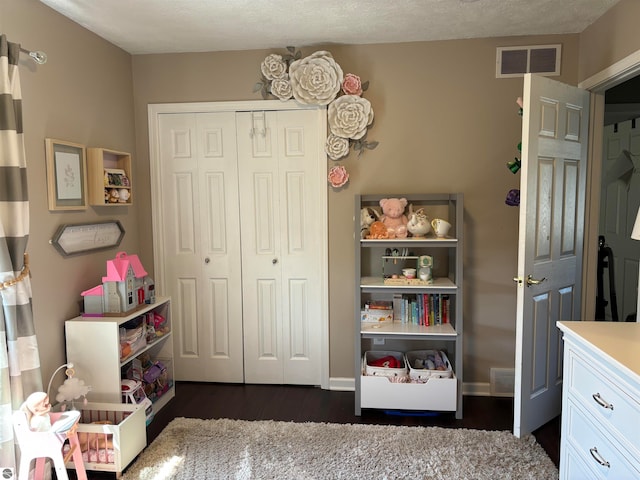 bedroom with a closet and dark hardwood / wood-style flooring