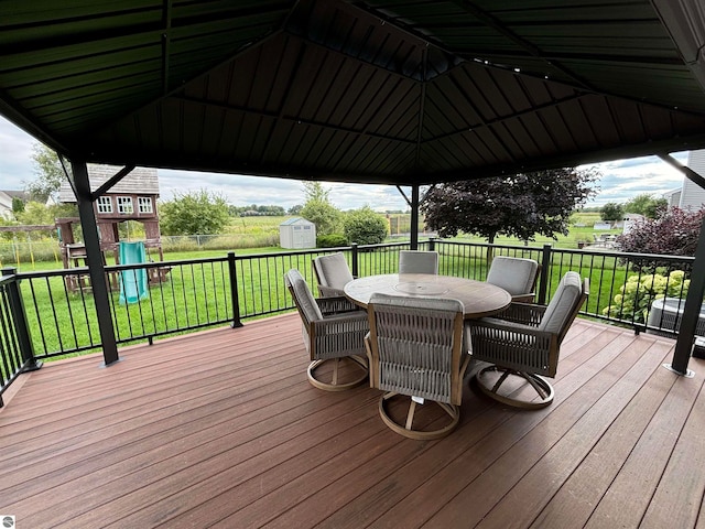 wooden deck featuring a gazebo and a storage shed