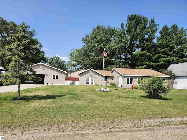 ranch-style home with a front yard and fence