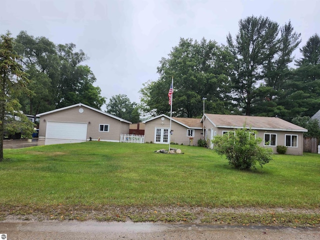 ranch-style house with a garage and a front lawn