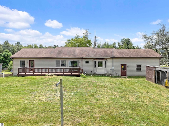 back of house with a wooden deck and a yard