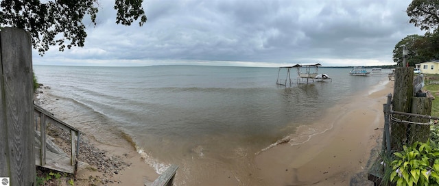 view of water feature with a dock and a view of the beach